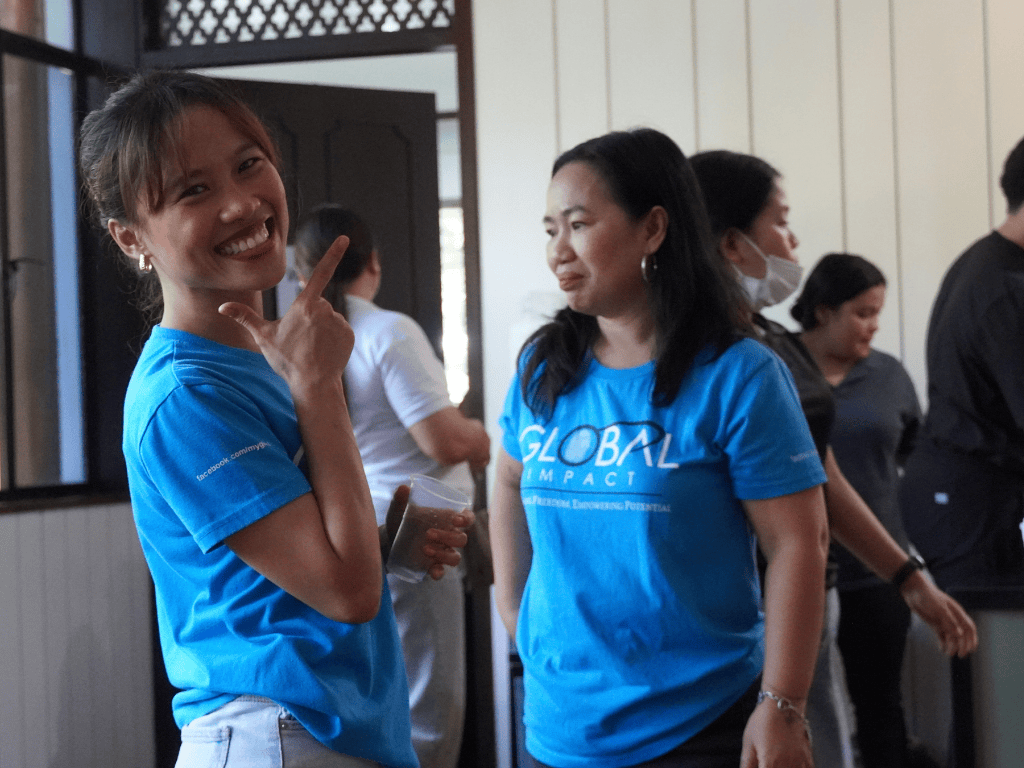 A Global Impact Team Member, Yani, smiling and posing for the camera