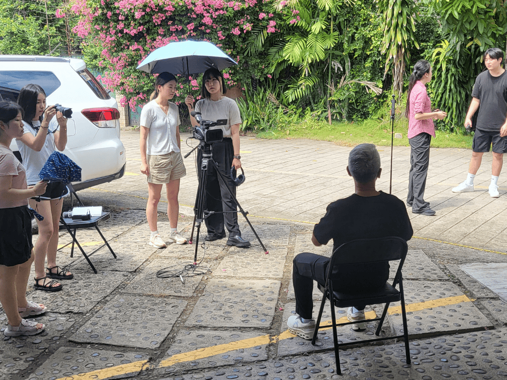 The production crew filming a talking-head style shot with Dr. Uribe