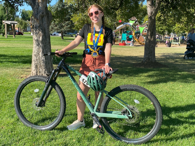 Emmy standing next to her bike